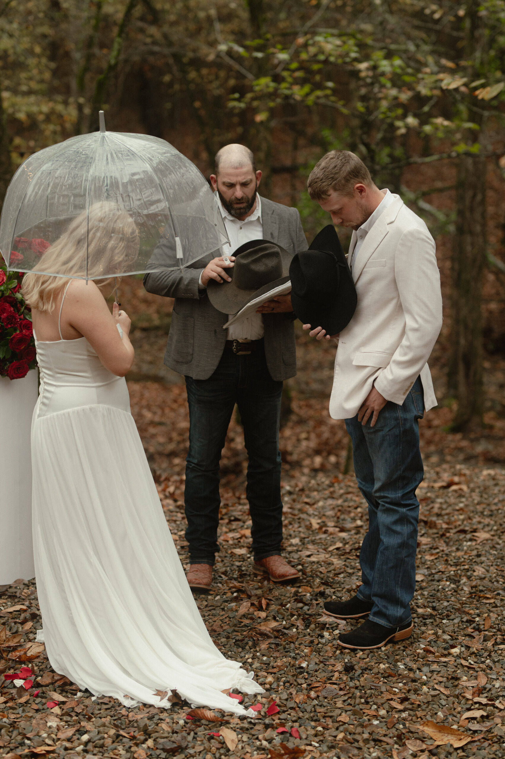 couple bowed in prayer at the alter in the rain